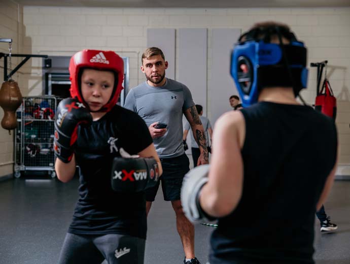 Boxing Academy coach watching over pupils Boxing Academy coach watching over pupils