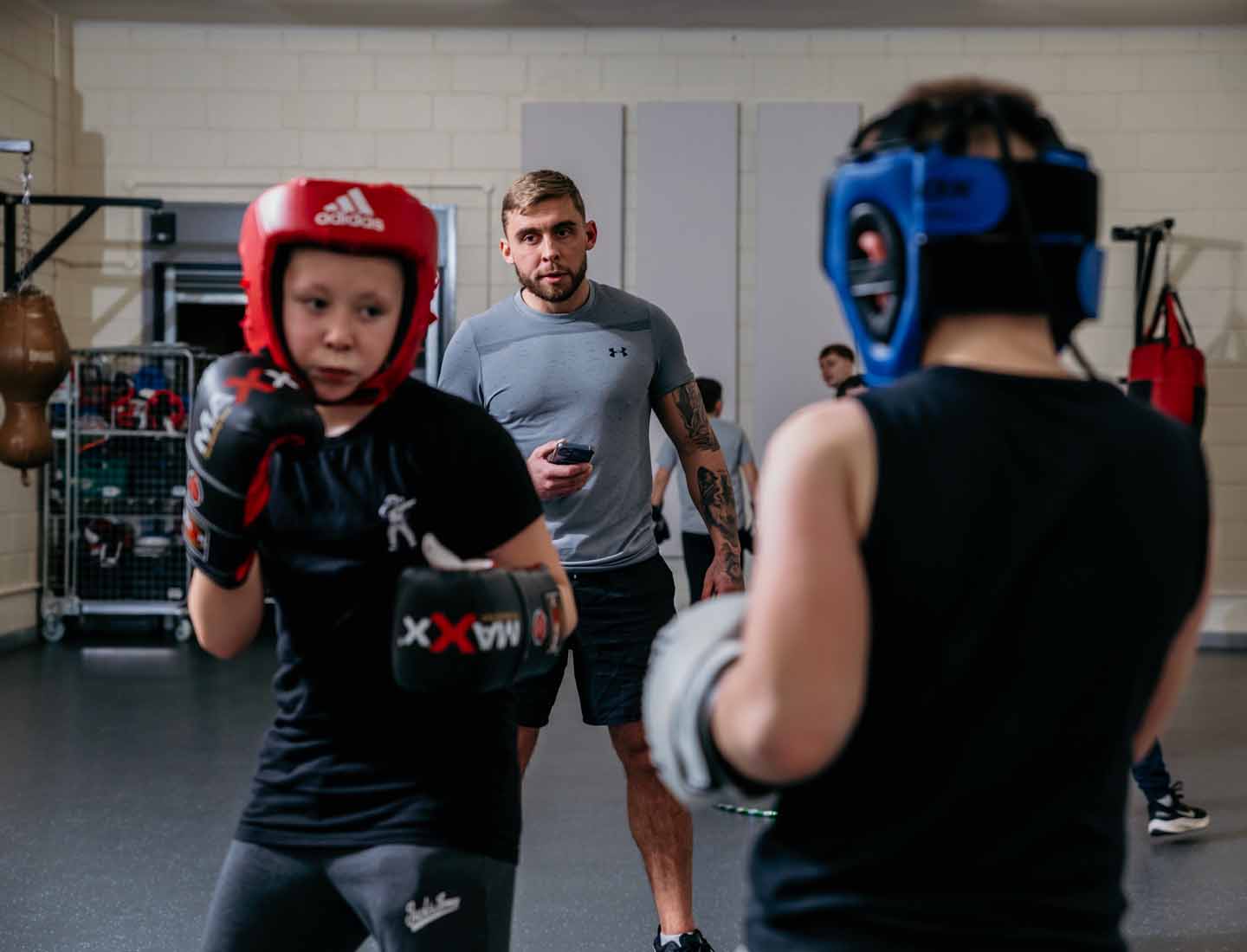 Boxing Academy coach watching over pupils Boxing Academy coach watching over pupils