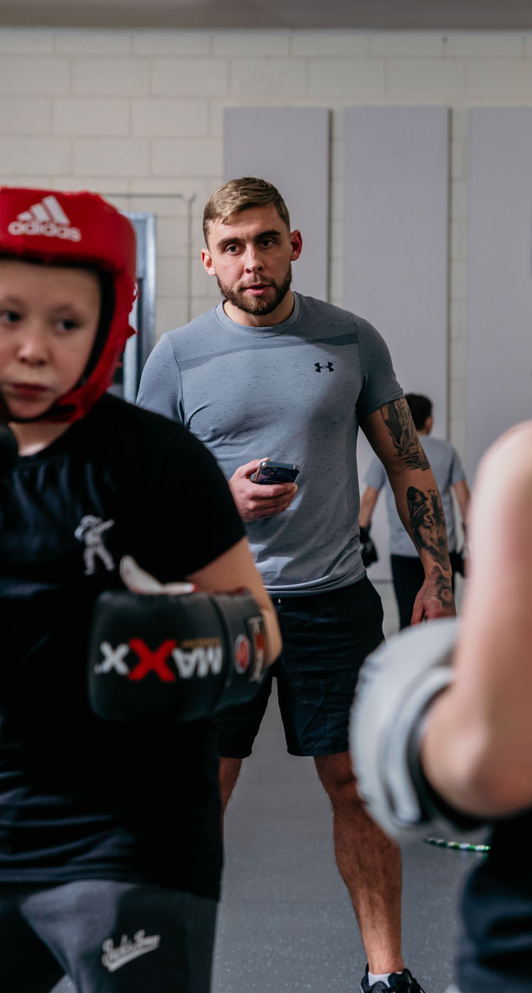 Boxing Academy coach watching over pupils Boxing Academy coach watching over pupils