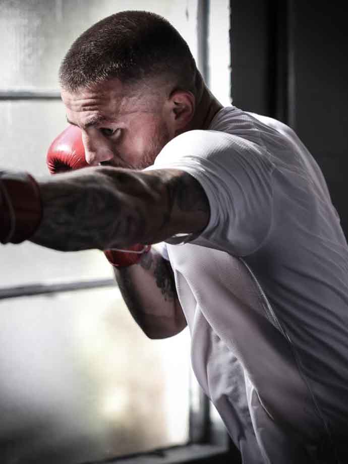 Jordan Reynolds throwing punches during boxing training