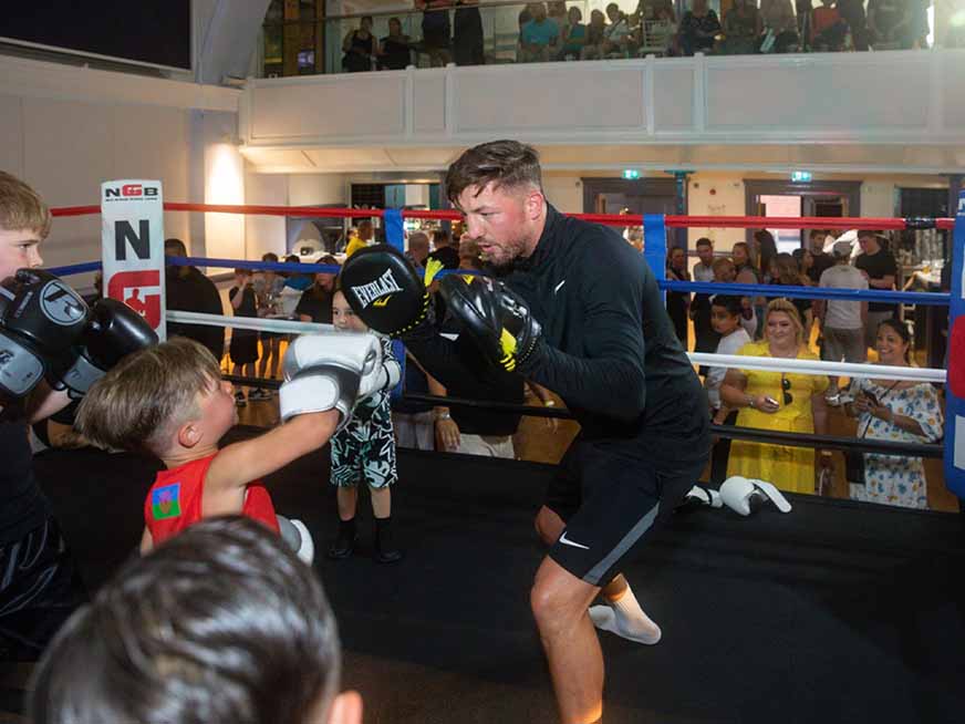 Kid training on boxing pads