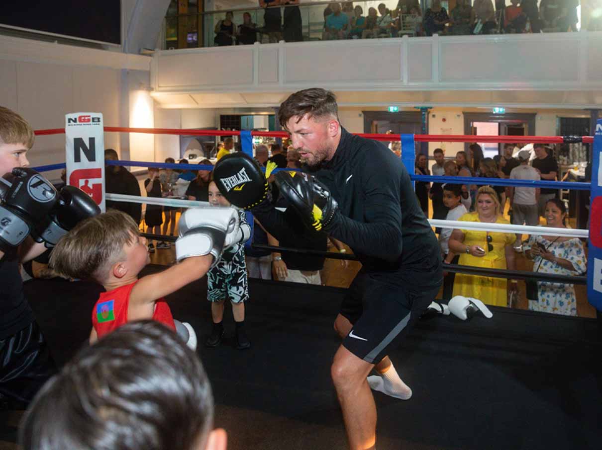 Kid training on boxing pads