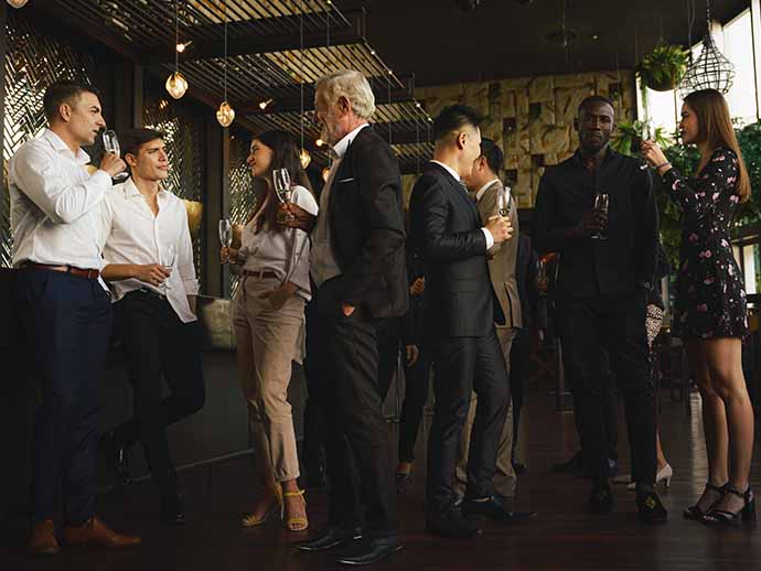 People dressed in suits having conversations