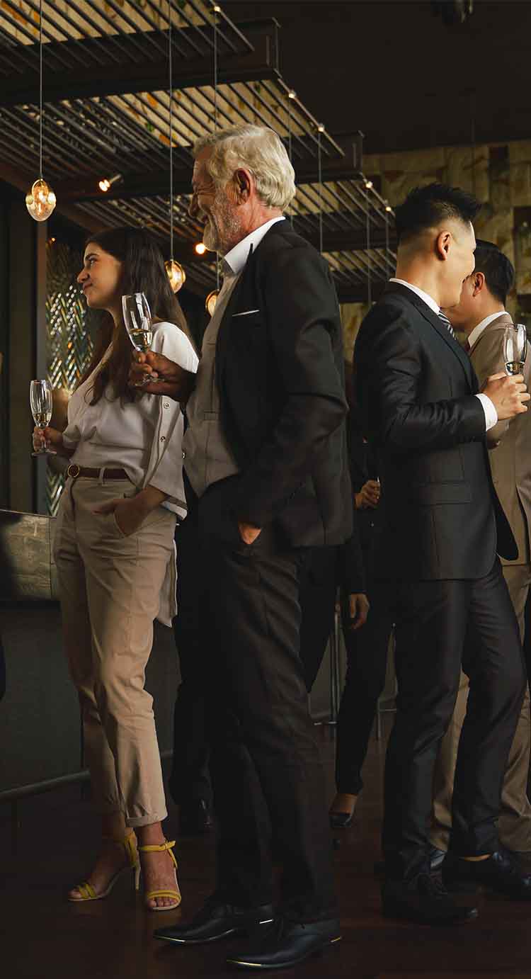 People dressed in suits having conversations