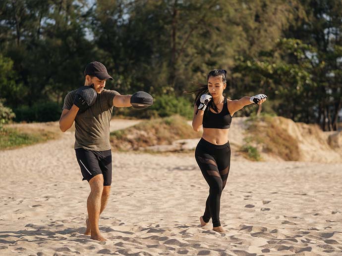 Woman boxing on a tropical beach Woman boxing on a tropical beach